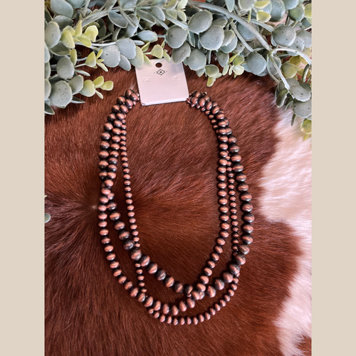 18-inch copper Navajo-style necklace with three pearl strands.