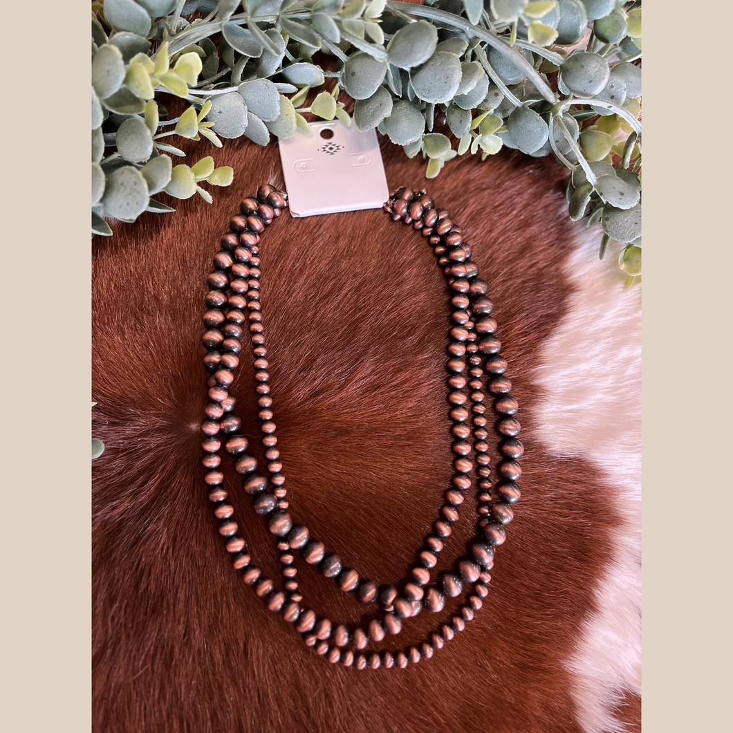 18-inch copper Navajo-style necklace with three pearl strands.
