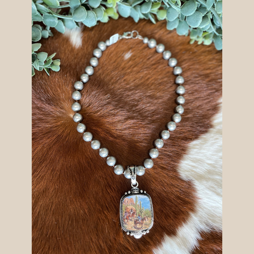 Navajo pearl style necklace with a western pendant depicting a cowboy and cactus scene.