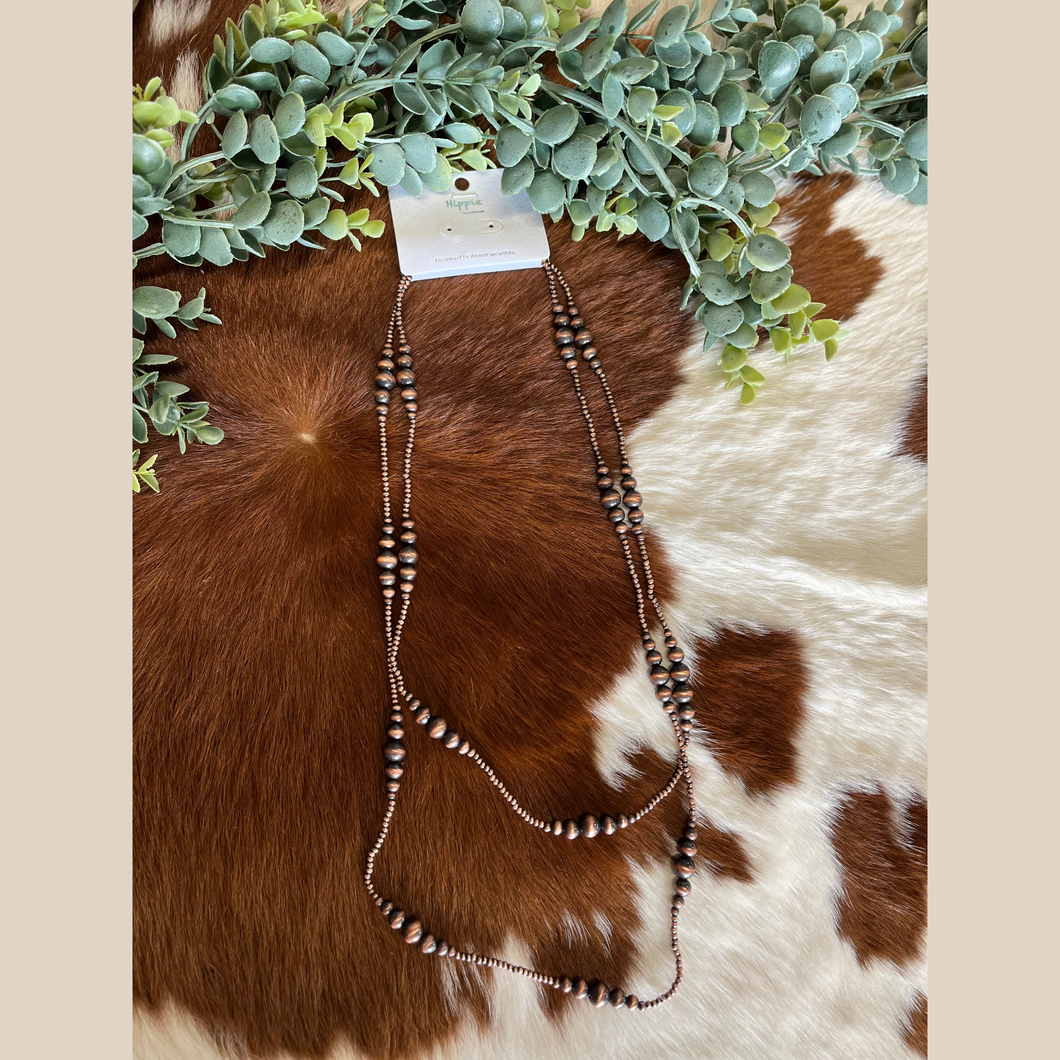 Long copper Navajo pearl style necklace with graduated beads.