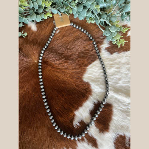 Long Navajo style pearl necklace with classic western design.