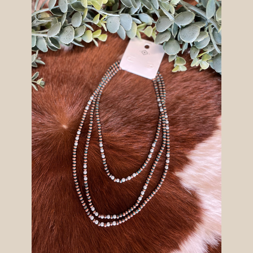 Three-row Navajo style necklace with copper beads with green accents, pearls.