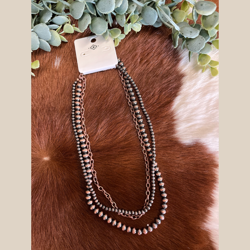Copper Navajo-style multi-strand necklace with pearls and a chain layer
