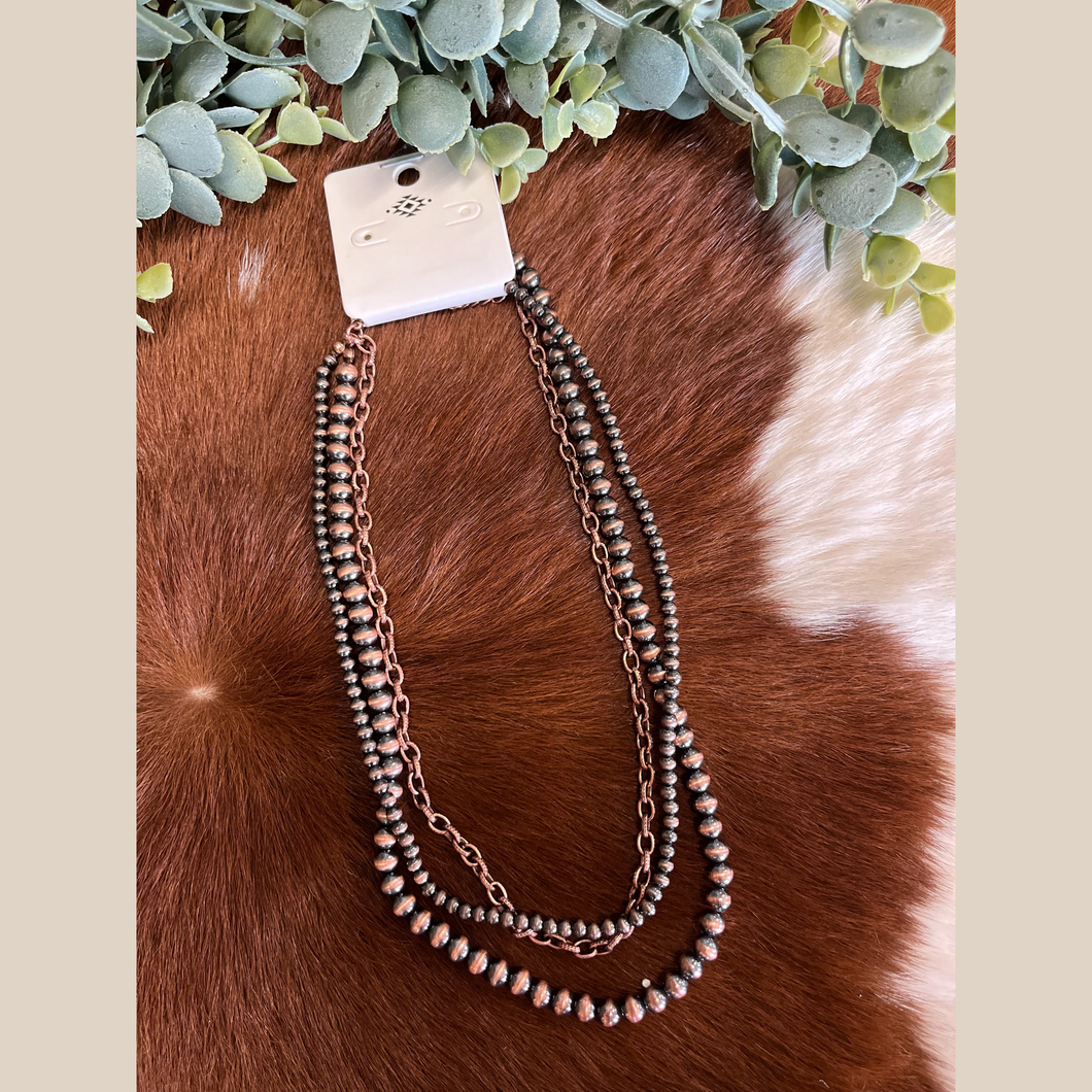 Copper Navajo-style multi-strand necklace with pearls and a chain layer
