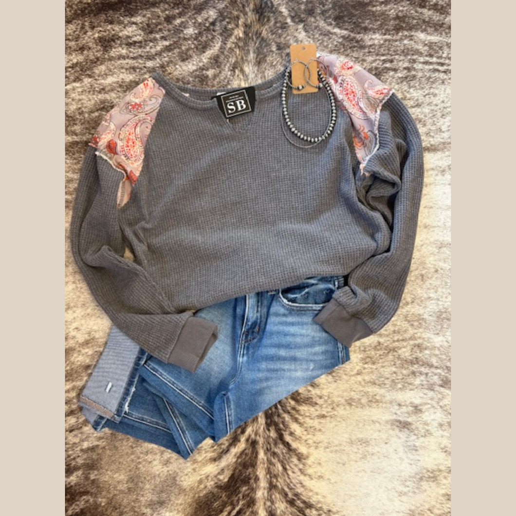 Gray waffle-knit top with paisley patch shoulders, styled with Navajo pearls.