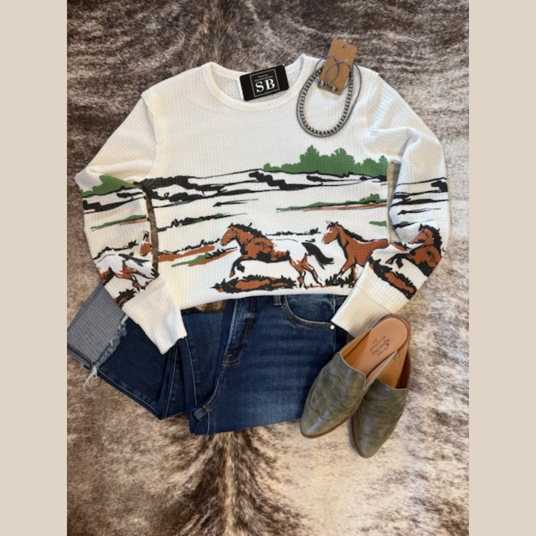 White waffle-knit top with galloping horse graphic and western prairie scene.