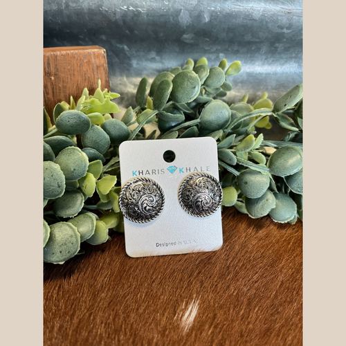 Pair of round stud earrings with tooled design and rope-edge detail in silver and copper.