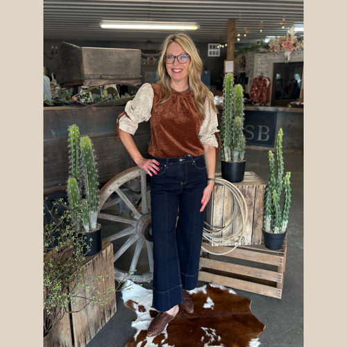 Rust-brown velvet top with tan embroidered three-quarter sleeves and velvet tie accents.