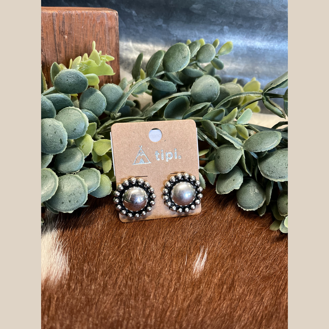 Pair of silver concho stud earrings in western style.