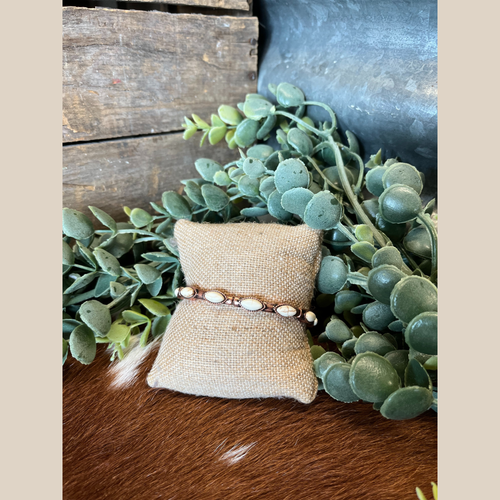 Copper stretch bracelet with white oval semi-stones and western accents.