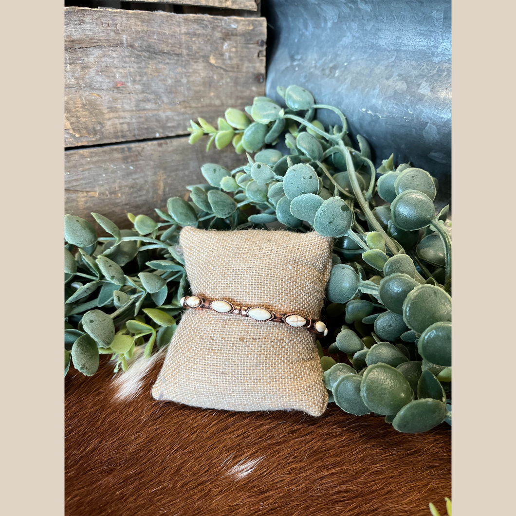 Copper stretch bracelet with white oval semi-stones and western accents.